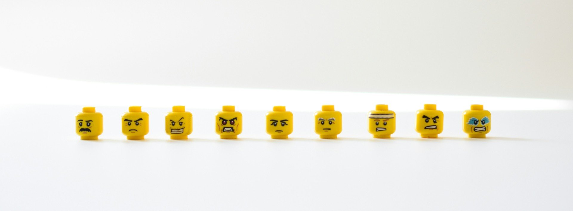 Orphaned negatives: a row of Lego heads with negative expressions