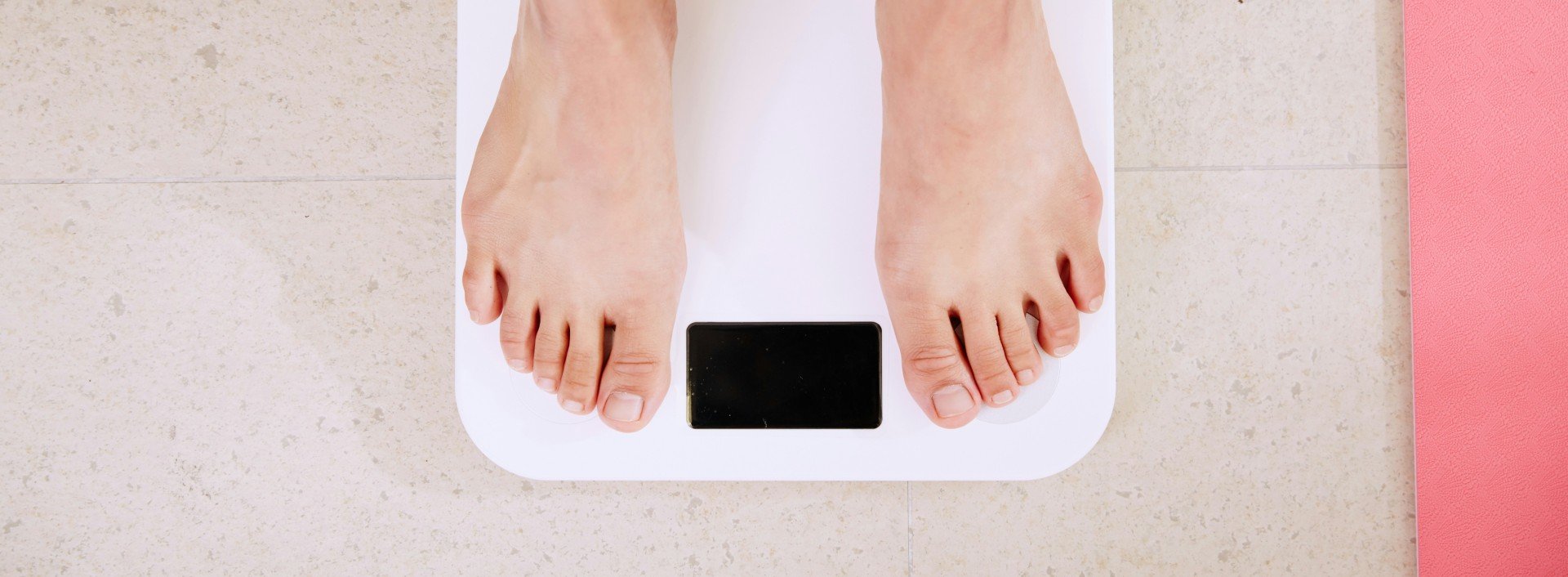 How to talk about weight: a person stands on a bathroom scale.