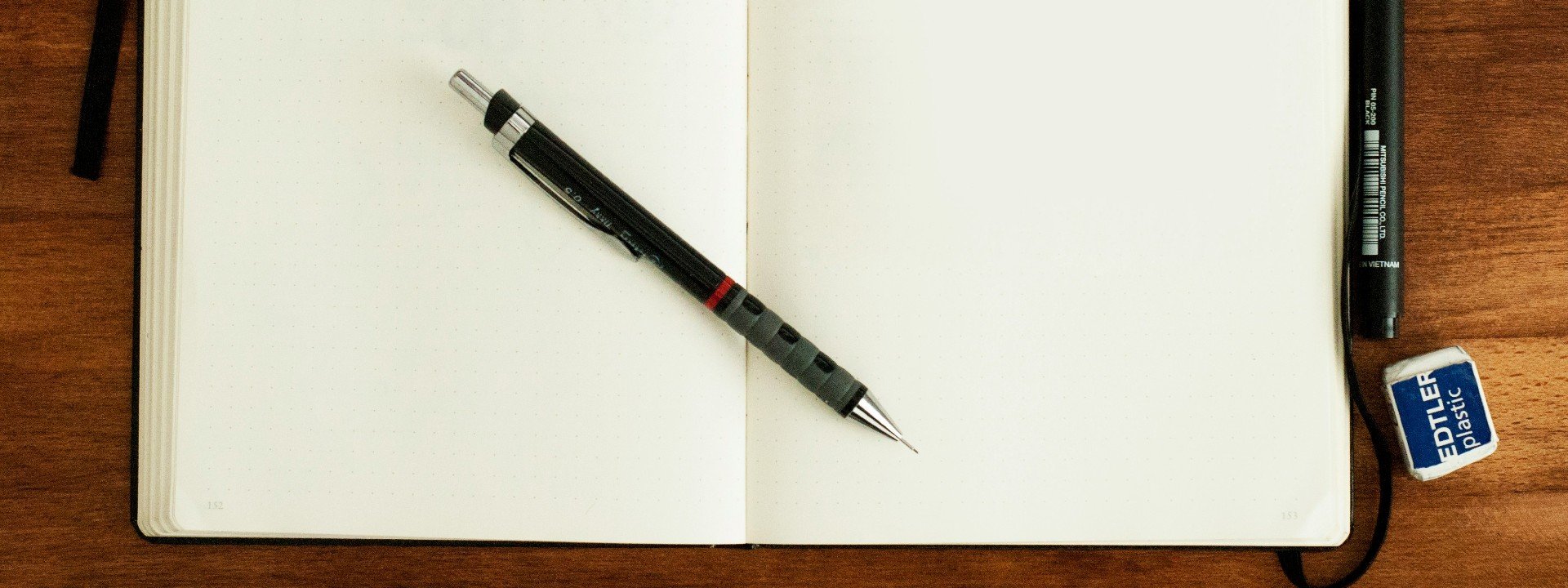 Phrasal verb get down: A notebook and pen sit on a table ready for someone to take notes, or get that down.