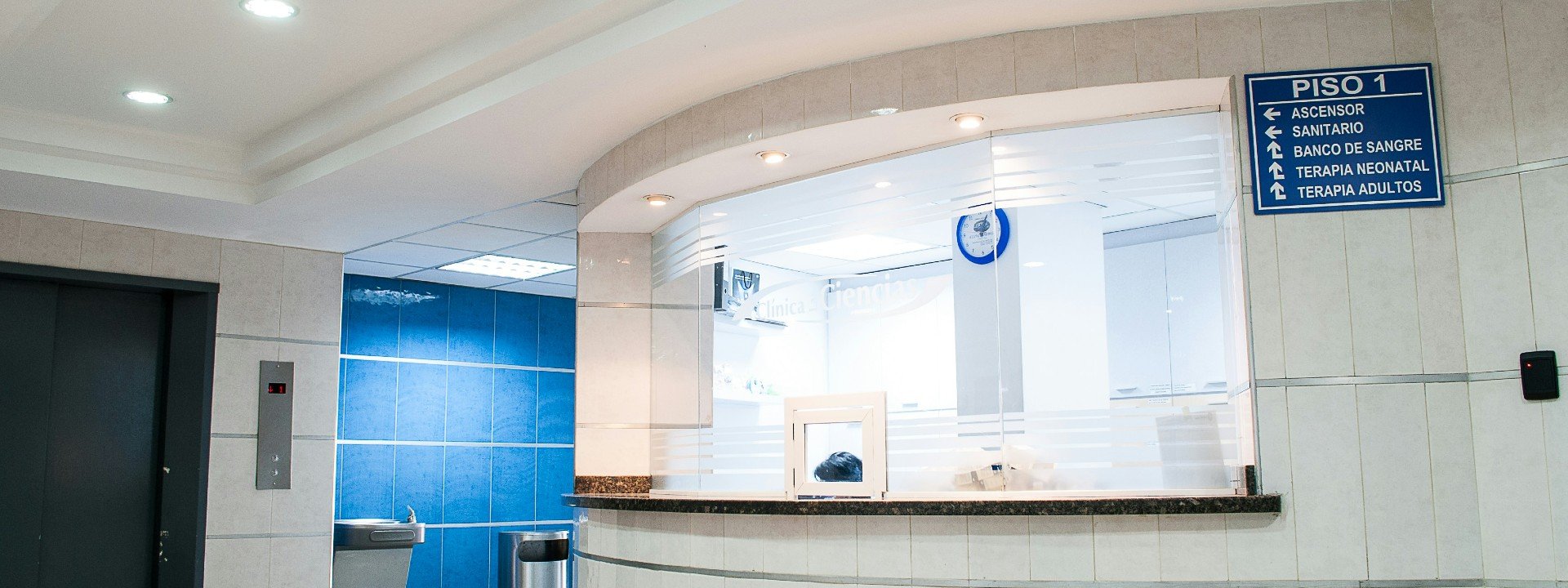 Hospital vocabulary: a check in counter at a hospital is shown with a sign giving directions to places in the hospital
